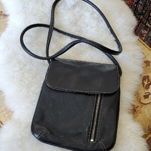 Tignanello Black Crossbody Bag with Flap Closure and Long Strap